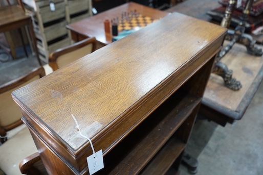 An Edwardian oak open bookcase, length 78cm, width 25cm, height 122cm